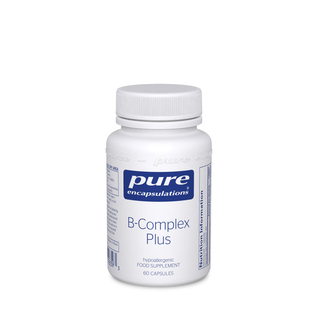 A bottle of Pure Encapsulations B-Complex Plus capsules, featuring a label highlighting active B vitamins and a few capsules beside it against a plain background