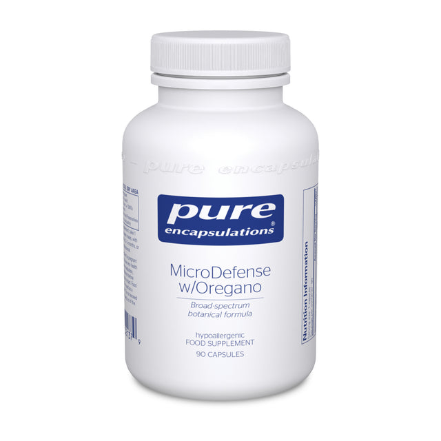 A bottle of Pure Encapsulations MicroDefense capsules containing a botanical blend with oregano oil, olive leaf, wormwood extract, and clove powder for broad-spectrum immune support