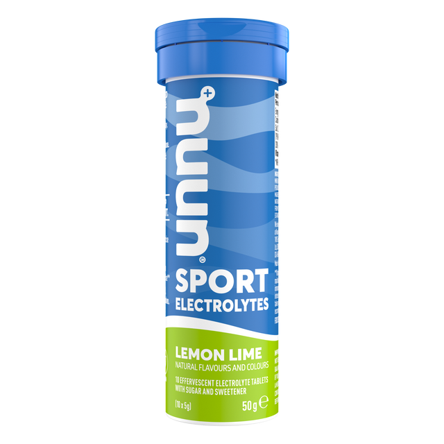 A close-up of Nuun Sport Electrolyte Lemon Lime effervescent tablets dissolving in water, showcasing fizzy bubbles and bright lemon-lime colour