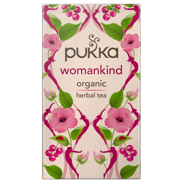 A cup of Pukka Womankind tea surrounded by herbs including chamomile, rose, hibiscus, shatavari, and vanilla to illustrate a balanced, organically sourced herbal tea blend for women's health