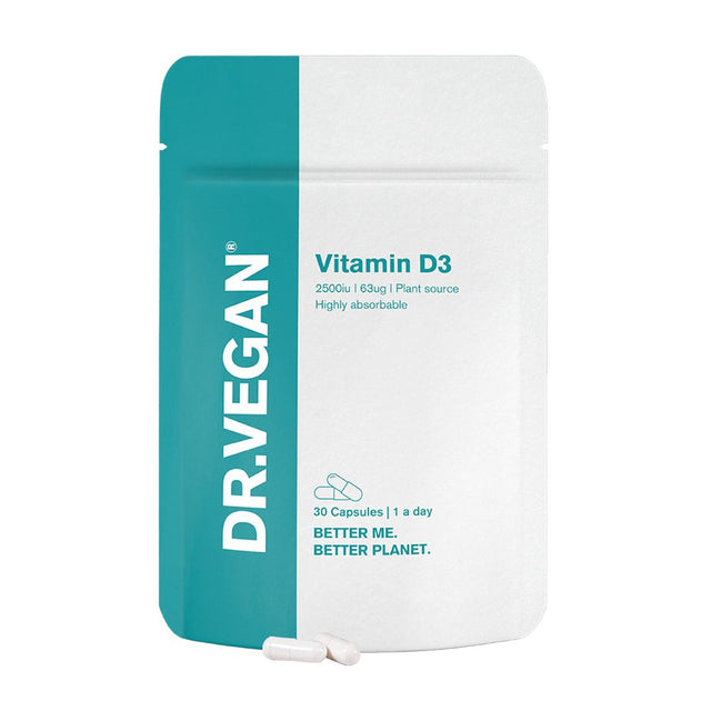 A close-up of DR VEGAN Vitamin D3 capsules in a clear container, highlighting their vegan, highly absorbable formula designed to support healthy bones, teeth, and immune function