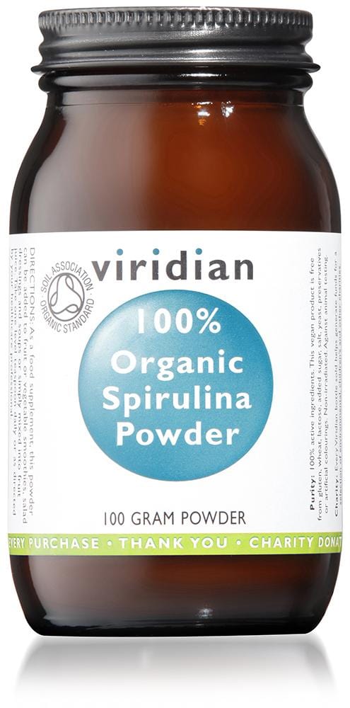 A close-up of Viridian's organic spirulina powder in a glass jar, showcasing vibrant green-blue coloured, finely ground algae, highlighting its natural, nutrient-rich appearance