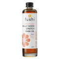 Close-up of the product label highlighting key ingredients like Holy Basil, Baobab Oil, and Wheatgerm Oil on the Fushi Really Good Stretch Mark Oil bottle