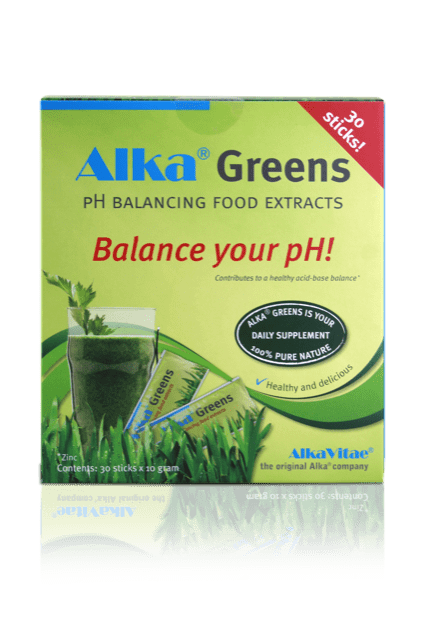 A close-up of a glass containing a vibrant green Alka Greens 30 Sticks supplement dissolved in water, highlighting its natural colour and texture, with the sachet placed beside it showing the product’s branding and packaging details