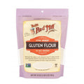 Freshly measured Bob's Red Mill Vital Wheat Gluten flour in a clear measuring cup