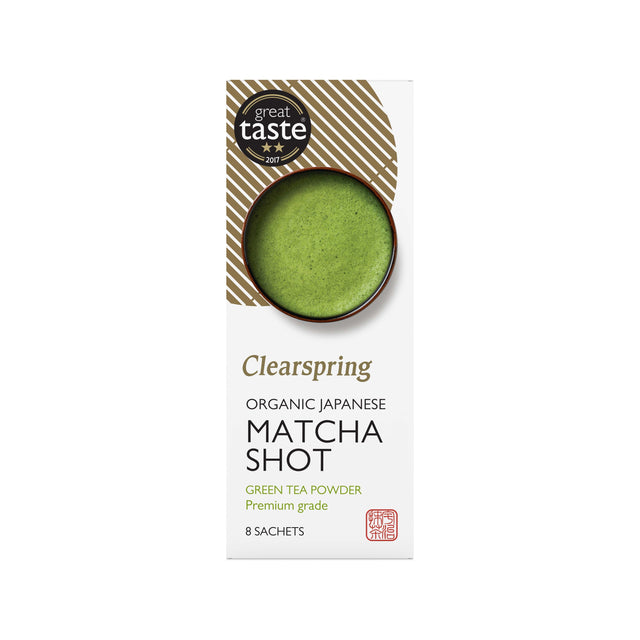 A vibrant green packet of Clearspring Japanese Matcha Shot with detailed product branding and fresh green tea leaves in the background