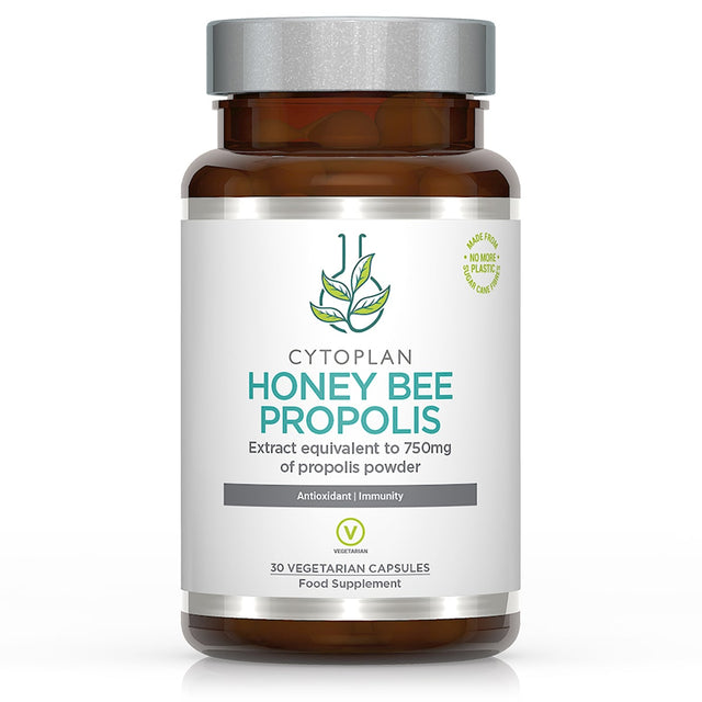 A close-up of Cytoplan Honey Bee Propolis capsules in a blister pack, showcasing small, green vegetable capsules containing a concentrated propolis extract, with detailed packaging and product information visible on the label