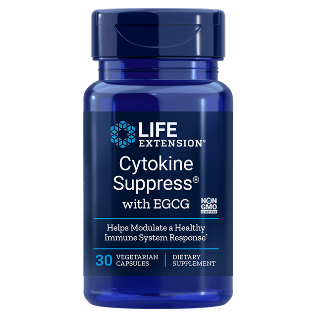 A close-up of a bottle of Life Extension Cytokine Suppress with EGCG capsules alongside fresh green tea leaves and mung beans, highlighting natural ingredients that support a healthy inflammatory response and immune system health