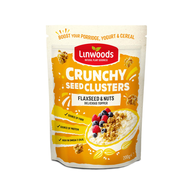 A close-up of Linwoods Crunchy Seed Cluster Flaxseed & Nuts showing a mix of seeds, cranberries, and mulberries in a transparent container
