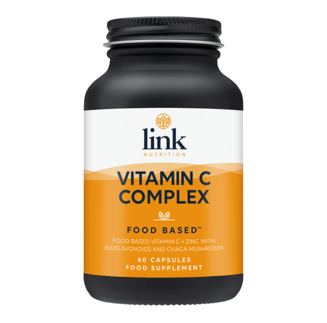 A close-up of Link Nutrition Vitamin C Complex capsules, showing 60 vegetarian capsules containing food-based vitamin C, bioflavonoids, zinc, and chaga mushroom extract in a clear container