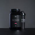 Close-up of Tom Oliver Diet Whey Strawberry 907g tub highlighting label and product features