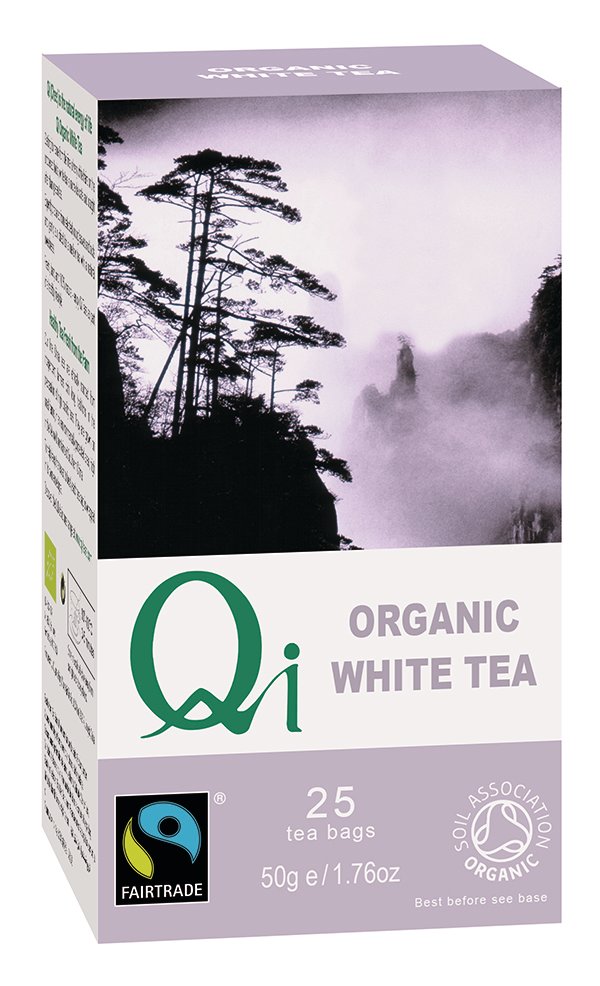 A close-up of Qi Organic White Tea in a teacup, showcasing its delicate yellowish brew and small white tea leaves, highlighting its natural sun-dried, organic quality and light, subtly sweet taste