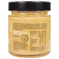 Serving spoon with a generous scoop of Honey Lovers Honeyboost Ginger & Lemon Honey highlighting its spiced, nourishing qualities