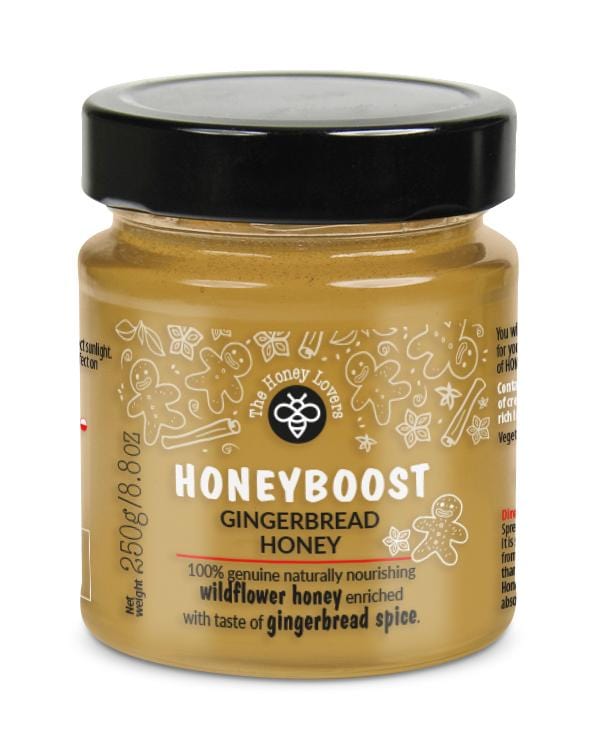 A jar of Honey Lovers Honeyboost Gingerbread with a spoon, showcasing its rich, golden honey infused with ginger and lemon pieces, highlighting its natural, nourishing qualities and aromatic spicy flavour