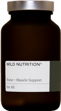 A close-up of Wild Nutrition Bone & Muscle Support capsules showing their size and shape