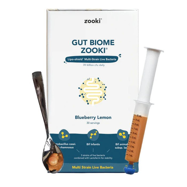 A close-up image showcasing the Zooki Gut Biome oral syringe containing a blueberry and lemon-flavoured probiotic supplement designed to support gut health with over 35 billion live bacteria