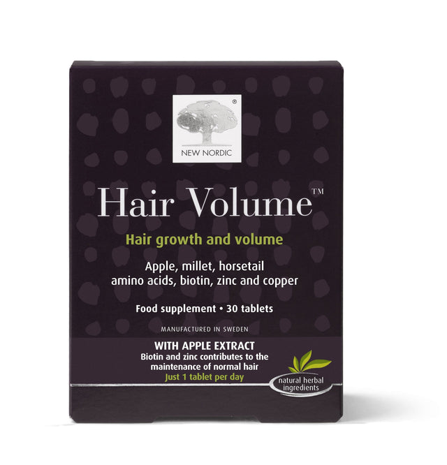 A close-up of a bottle of New Nordic Hair Volume 30 Tablets, showing the tablets and the product label highlighting natural ingredients like apple extract, vitamins, minerals, and herbal extracts for promoting healthy, voluminous hair from the inside out